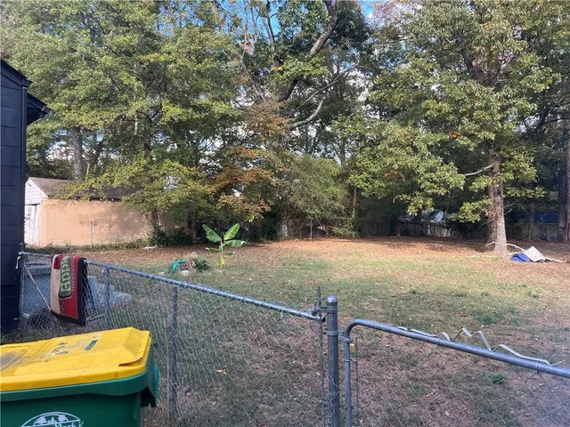 a view of a backyard with a tree
