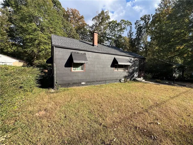 a backyard of a house with table and chairs