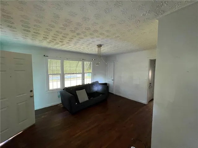 a living room with furniture and a air conditioner vent