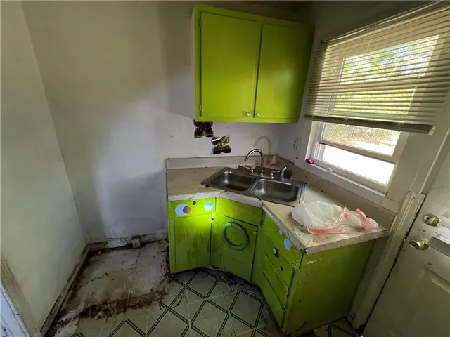 a room with a window and a sink