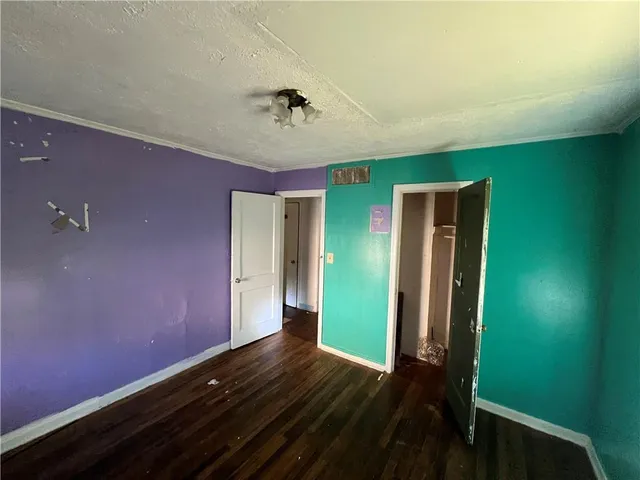 a view of room with hardwood floor and fan