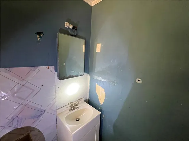 a bathroom with a sink and mirror
