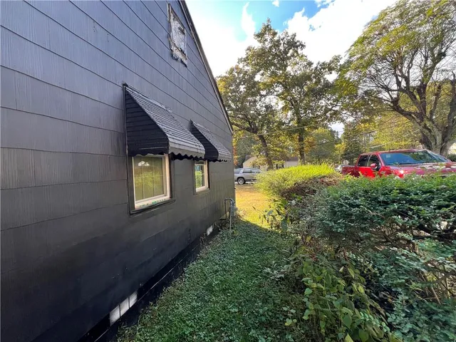a view of an house with backyard space and garden