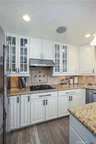 a kitchen with stainless steel appliances granite countertop a sink and cabinets