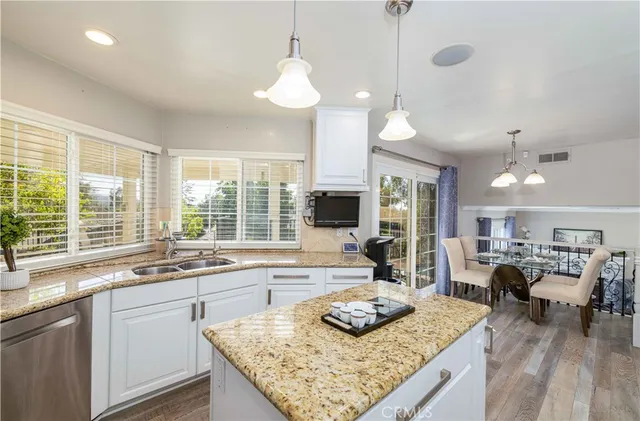a kitchen with sink stove and living room