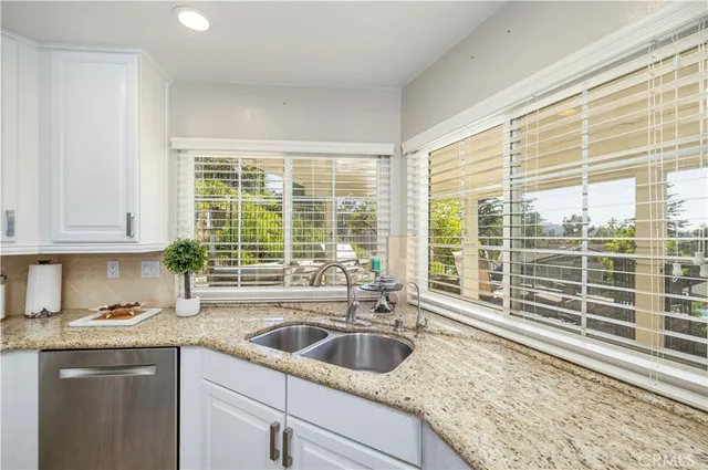 a kitchen with granite countertop a sink and a window