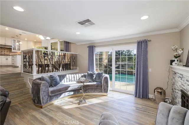 a living room with fireplace furniture and a large window