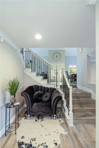 a living room with furniture ceiling fan and wooden floor