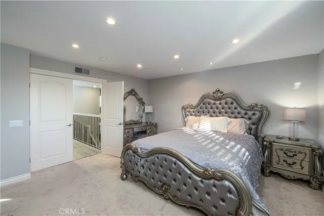 a bedroom with a bed and a mirror