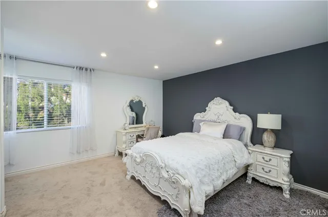 a bedroom with a bed and a chair