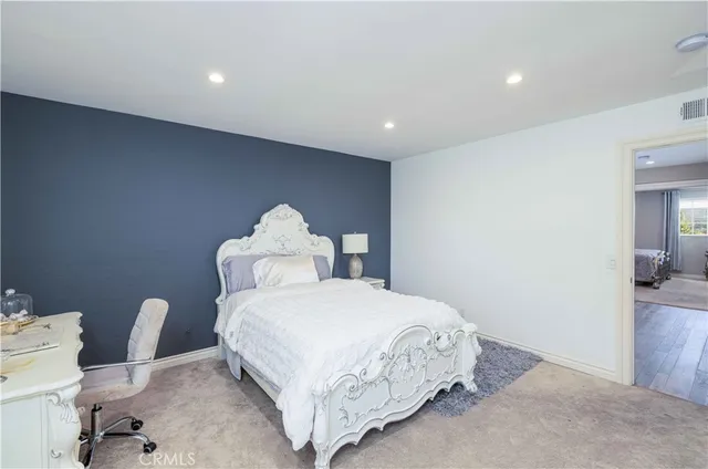 a bedroom with a bed and a chair