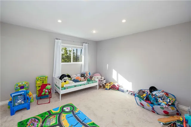 a bedroom with a bed and a desk