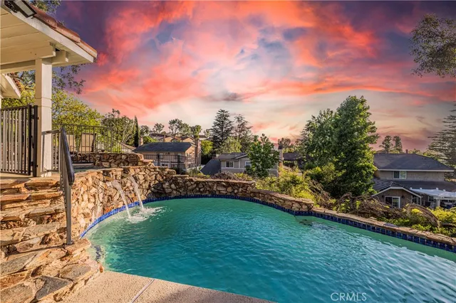 a view of balcony with chairs and wooden fence