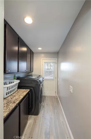 a front view of a house with a yard and flower plants