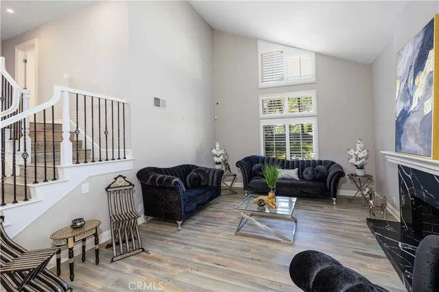 a living room with furniture fireplace and a window