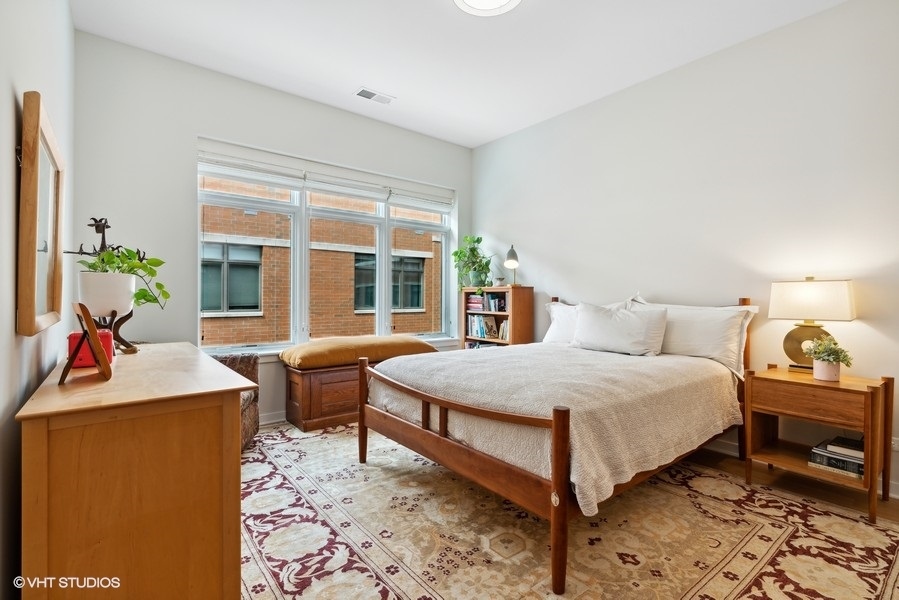 1648 South Prairie Avenue, Unit 2 Chicago, IL 60616 - Photo 11 of 19 a bedroom with a bed and wooden floor
