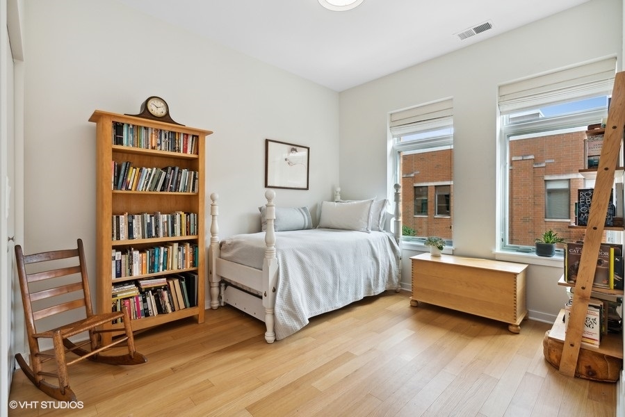 1648 South Prairie Avenue, Unit 2 Chicago, IL 60616 - Photo 14 of 19 a bedroom with a bed and a book shelf