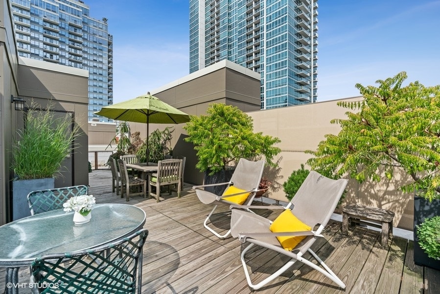 1648 South Prairie Avenue, Unit 2 Chicago, IL 60616 - Photo 18 of 19 a view of a backyard with table and chairs under an umbrella