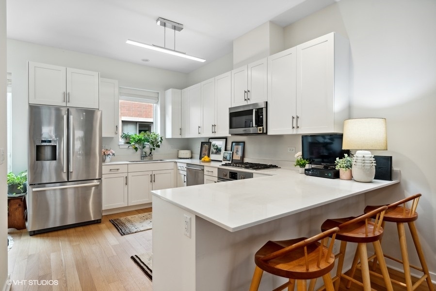 1648 South Prairie Avenue, Unit 2 Chicago, IL 60616 - Photo 5 of 19 a kitchen with a refrigerator a stove a sink and a microwave