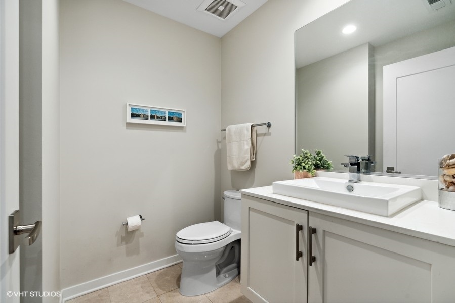 1648 South Prairie Avenue, Unit 2 Chicago, IL 60616 - Photo 10 of 19 a bathroom with a sink a toilet and mirror