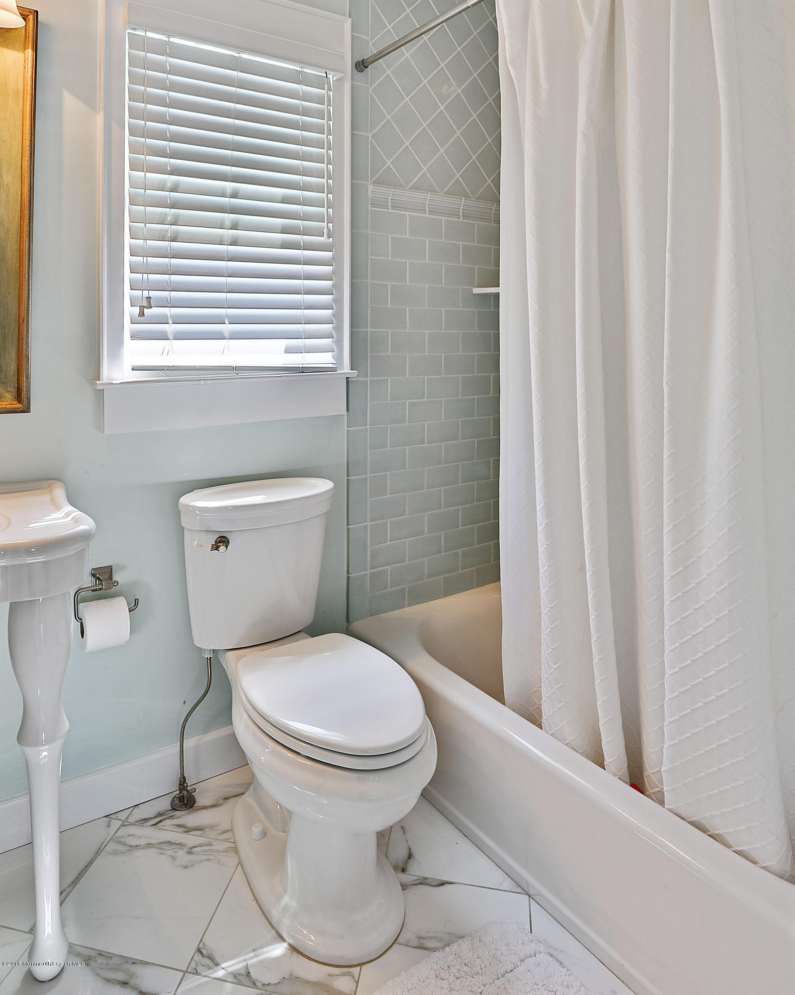 6 Via Ripa Sea Bright, NJ 07760 - Photo 23 of 25 a white toilet sitting next to a small window