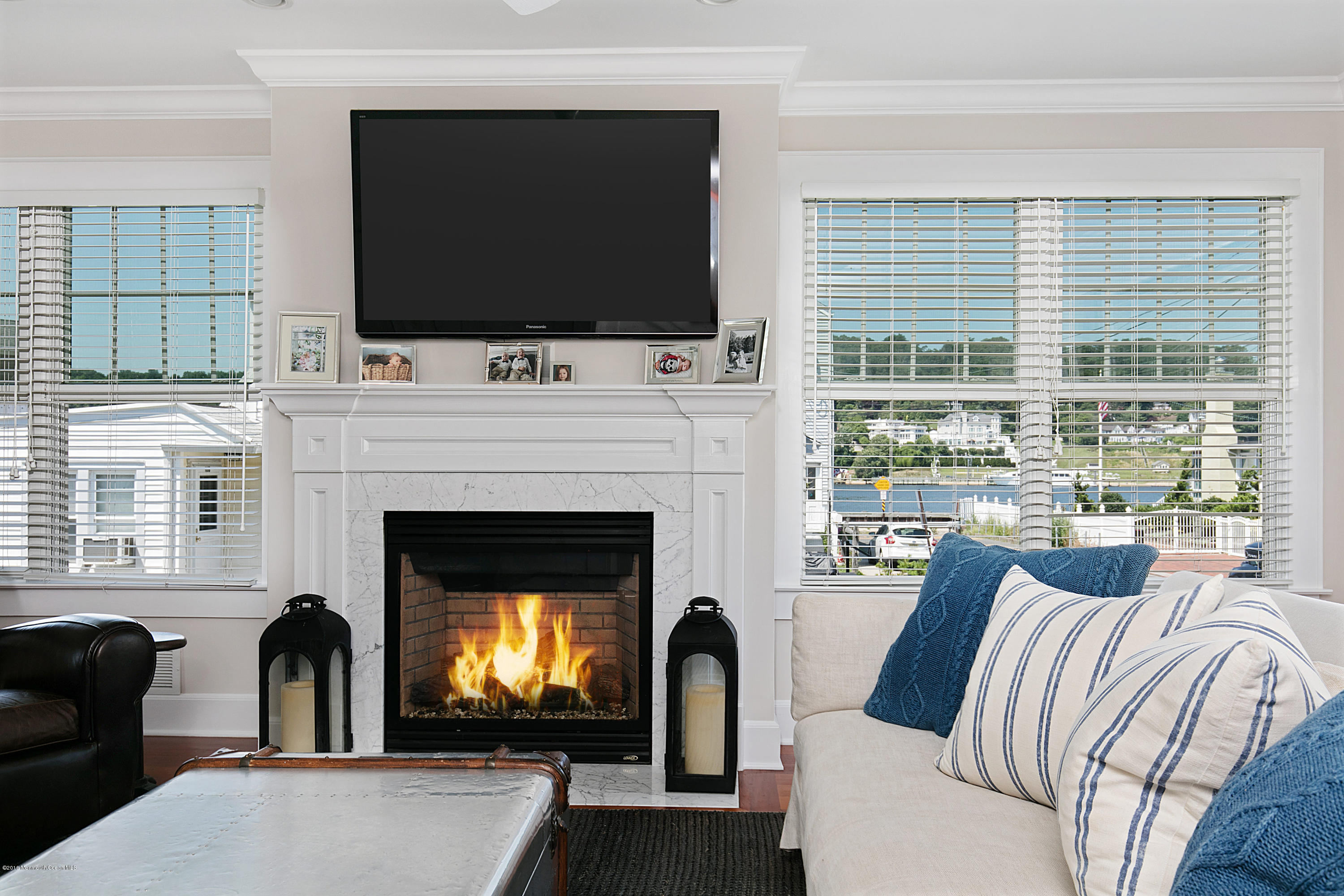 6 Via Ripa Sea Bright, NJ 07760 - Photo 9 of 25 a living room with furniture a flat screen tv and a fireplace