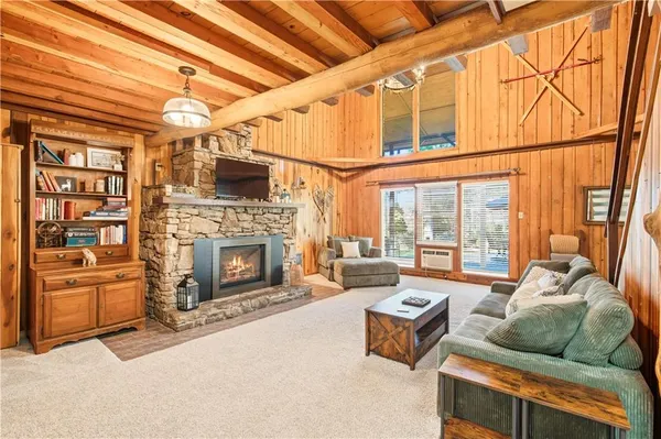 a living room with furniture a fireplace and next to a window
