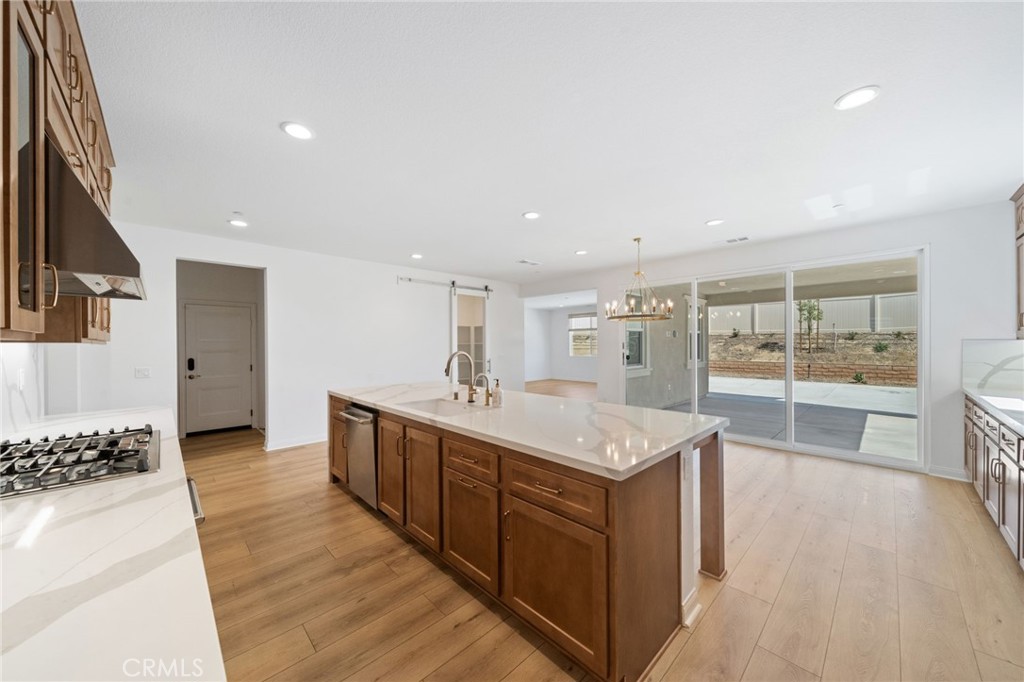 39565 Caladium Drive Temecula, CA 92591 - Photo 11 of 66 a large kitchen with kitchen island a large counter top and stainless steel appliances