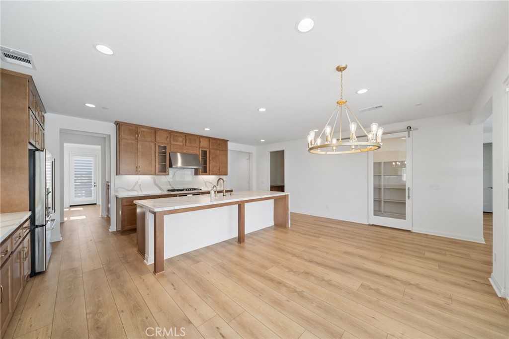 39565 Caladium Drive Temecula, CA 92591 - Photo 12 of 66 Chef's Kitchen with Dining Nook. Walk in Pantry Behind the glass barn door.