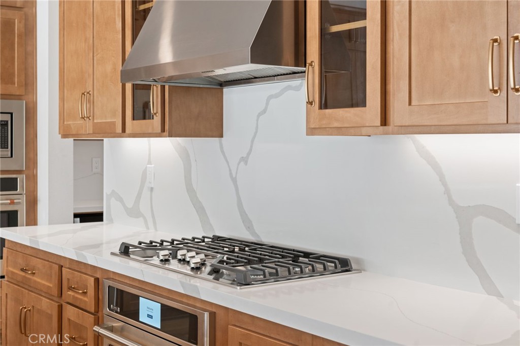 39565 Caladium Drive Temecula, CA 92591 - Photo 15 of 66 a kitchen with a stove and a window