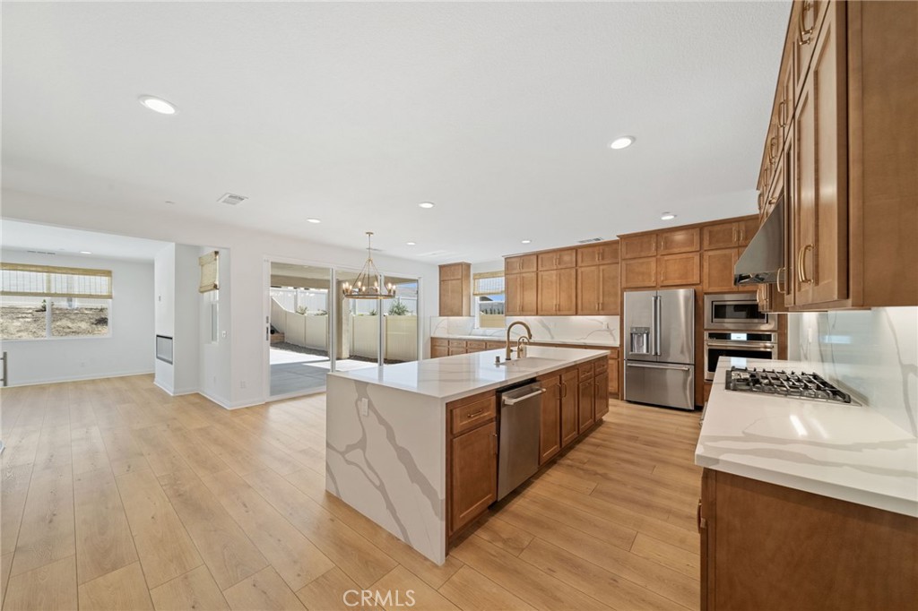 39565 Caladium Drive Temecula, CA 92591 - Photo 17 of 66 a kitchen with stainless steel appliances granite countertop a stove and a sink