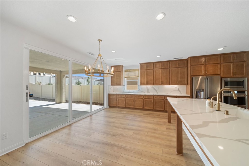 39565 Caladium Drive Temecula, CA 92591 - Photo 18 of 66 a kitchen with stainless steel appliances kitchen island granite countertop a sink and cabinets