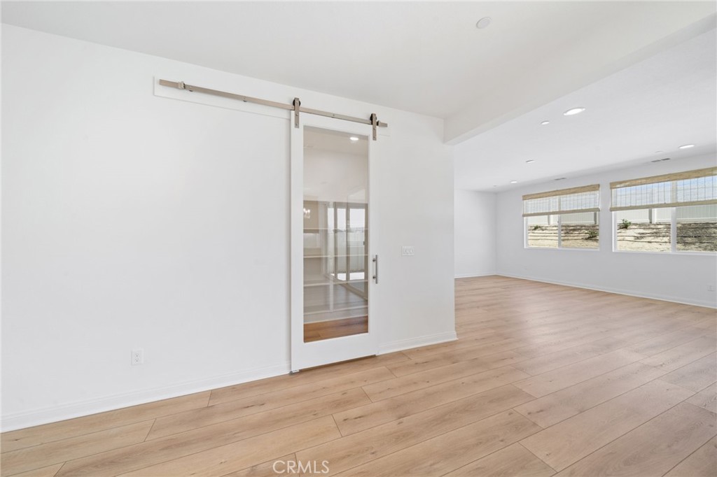 39565 Caladium Drive Temecula, CA 92591 - Photo 19 of 66 an empty room with wooden floor and windows