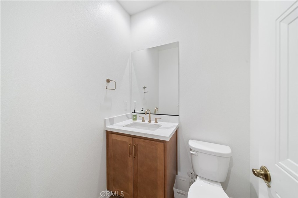 39565 Caladium Drive Temecula, CA 92591 - Photo 29 of 66 a bathroom with a sink toilet and mirror