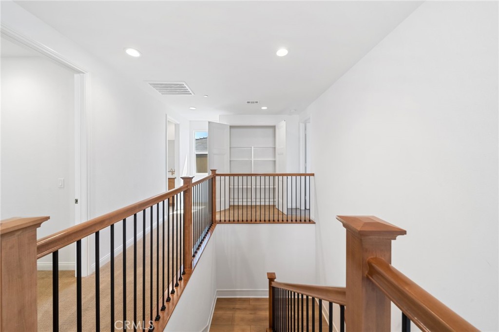 39565 Caladium Drive Temecula, CA 92591 - Photo 39 of 66 a view of a hallway with wooden floor and a window