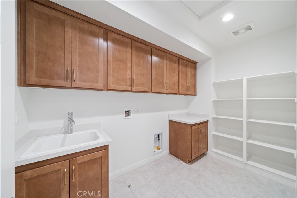 39565 Caladium Drive Temecula, CA 92591 - Photo 41 of 66 a room with cabinets and dust bin
