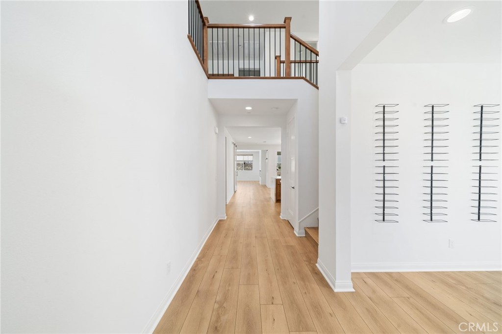 39565 Caladium Drive Temecula, CA 92591 - Photo 7 of 66 a view of a hallway with wooden floor and staircase