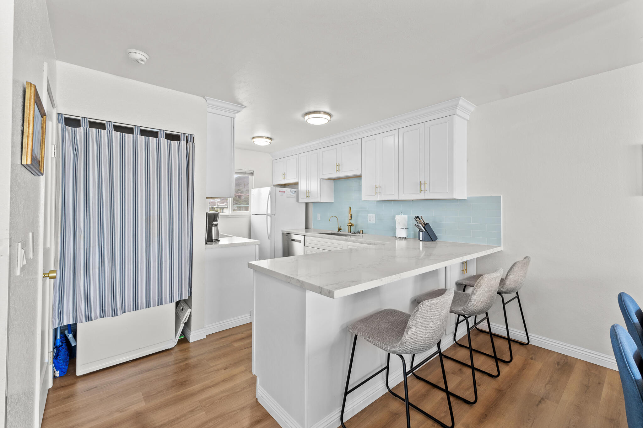 77 North Ocean Avenue, Unit 12 Cayucos, CA 93430 - Photo 15 of 41 a kitchen with stainless steel appliances granite countertop a white cabinets and wooden floor