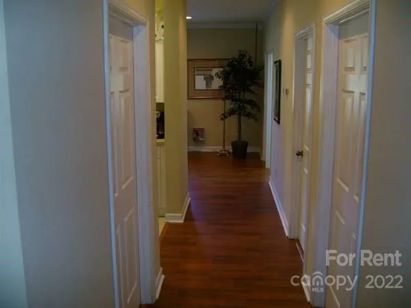 a view of a hallway with a wooden floor