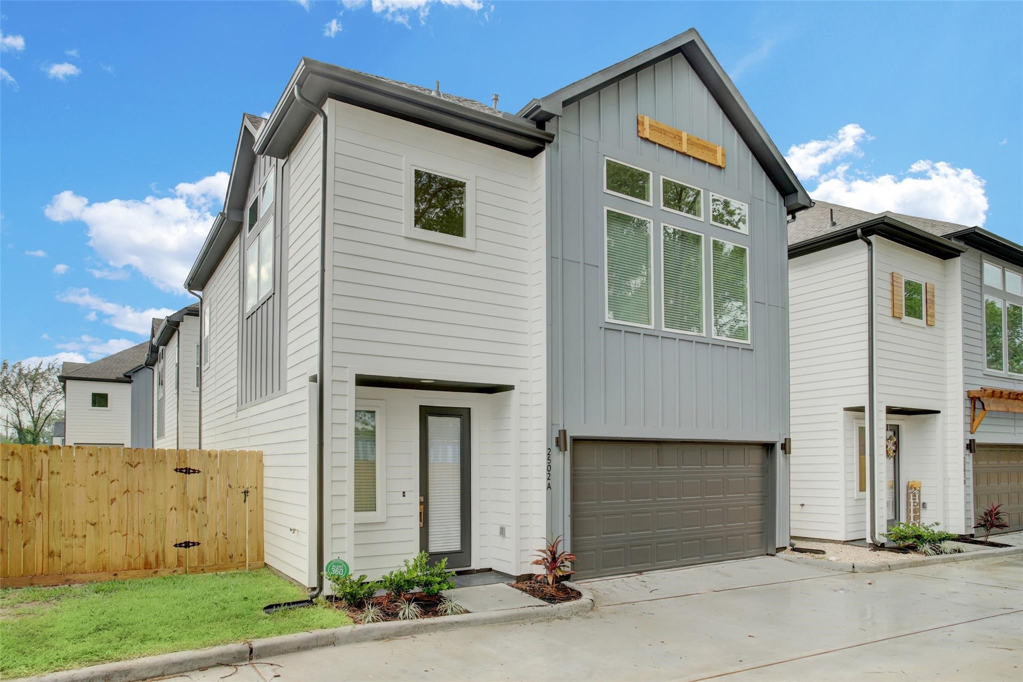 a view of a house with a yard and garage