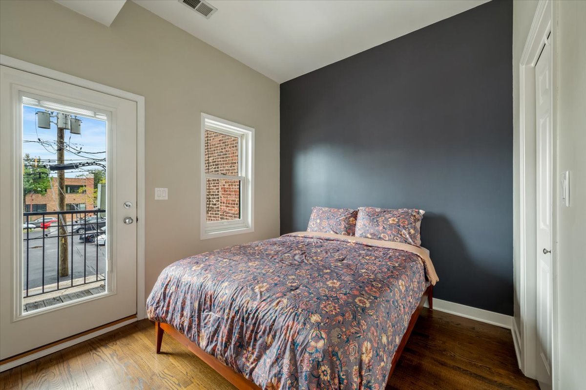 428 North Noble Street, Unit 2 Chicago, IL 60642 - Photo 13 of 20 a bedroom with a bed and wooden floor