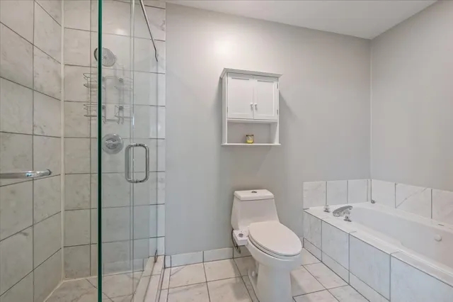 a white toilet sitting next to a bathroom sink