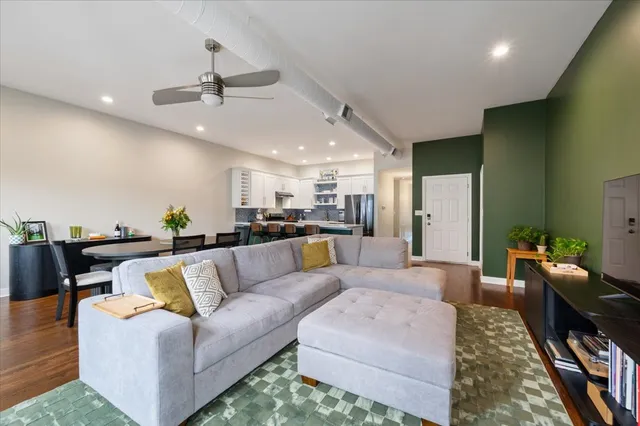 a view of a living room kitchen and a chandelier