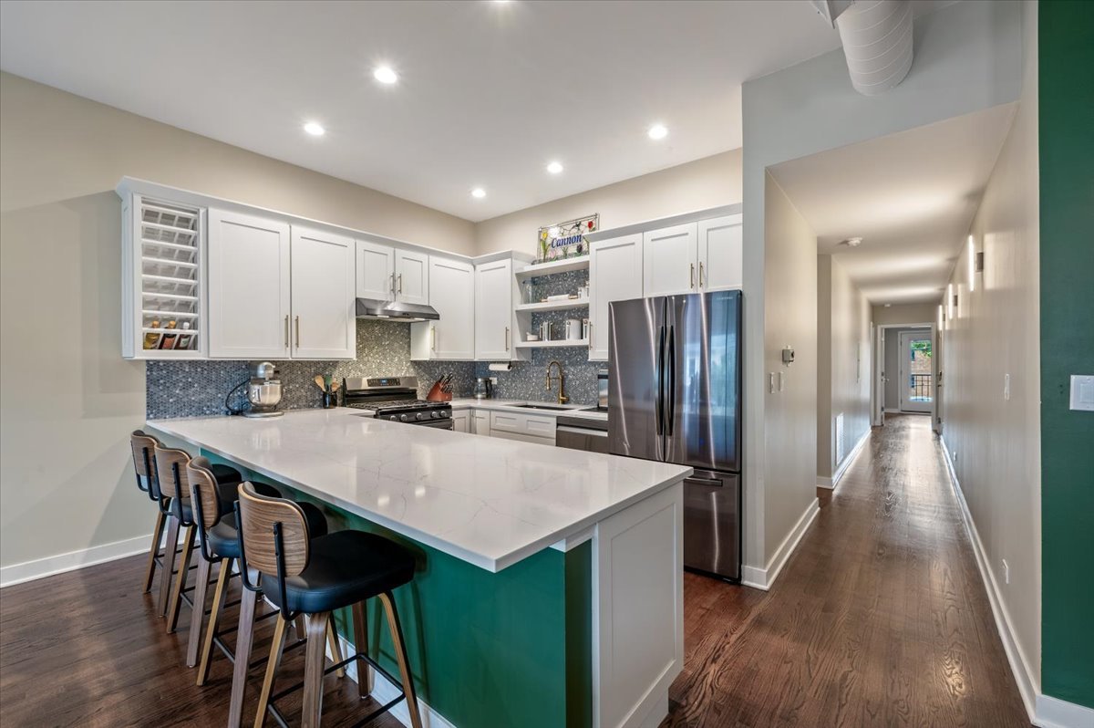 428 North Noble Street, Unit 2 Chicago, IL 60642 - Photo 8 of 20 a kitchen with refrigerator and chairs