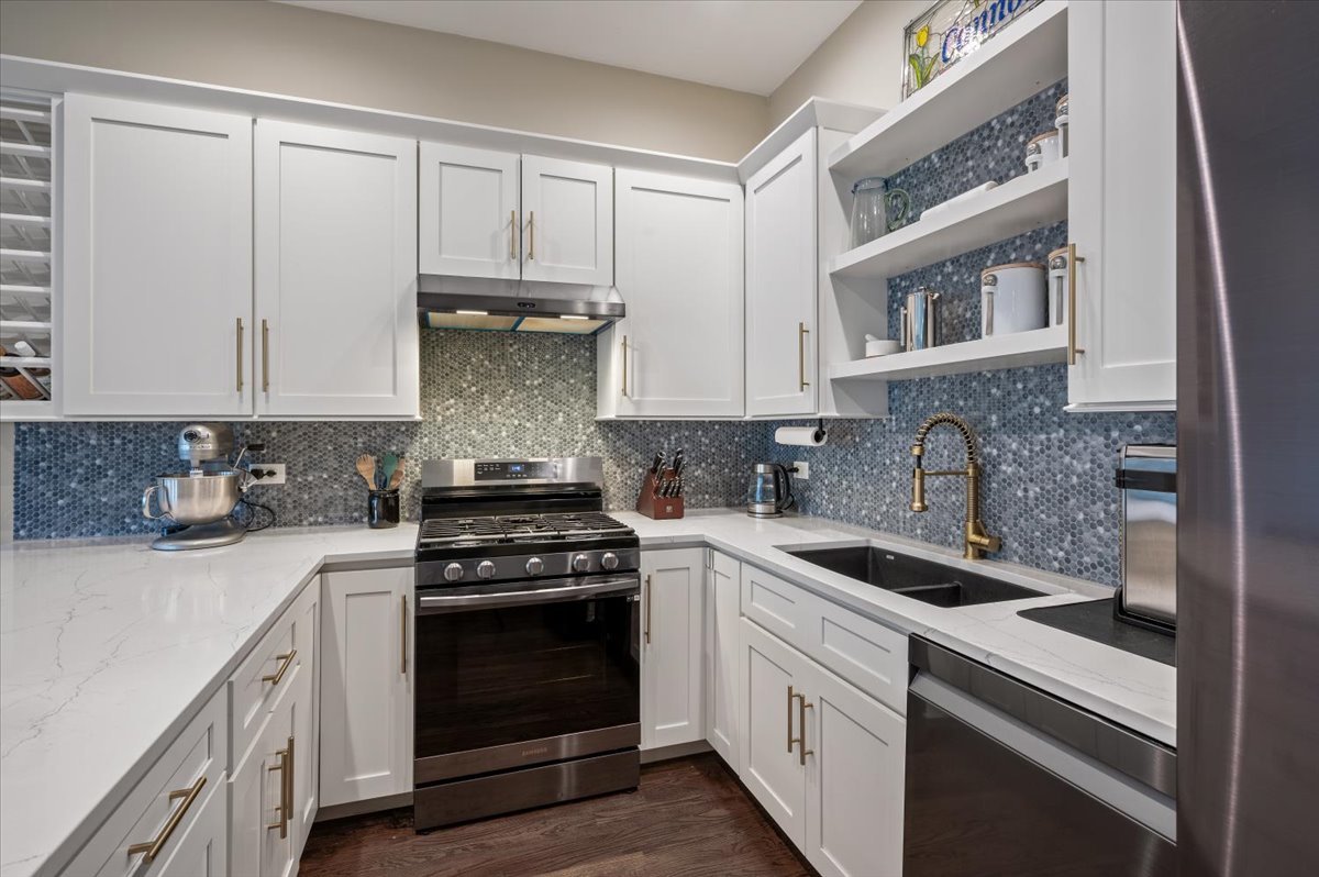 428 North Noble Street, Unit 2 Chicago, IL 60642 - Photo 9 of 20 a kitchen with stainless steel appliances granite countertop white cabinets and a stove a oven with white countertops