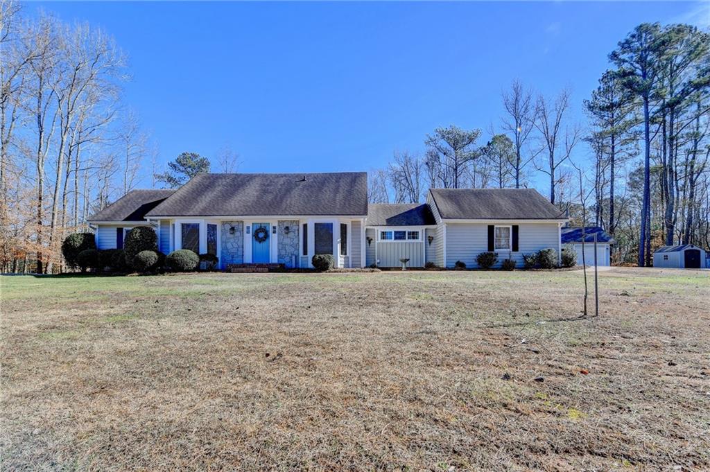 3215 Echols Road Cumming, GA 30041 - Photo 1 of 1 a front view of house with yard and trees in the background