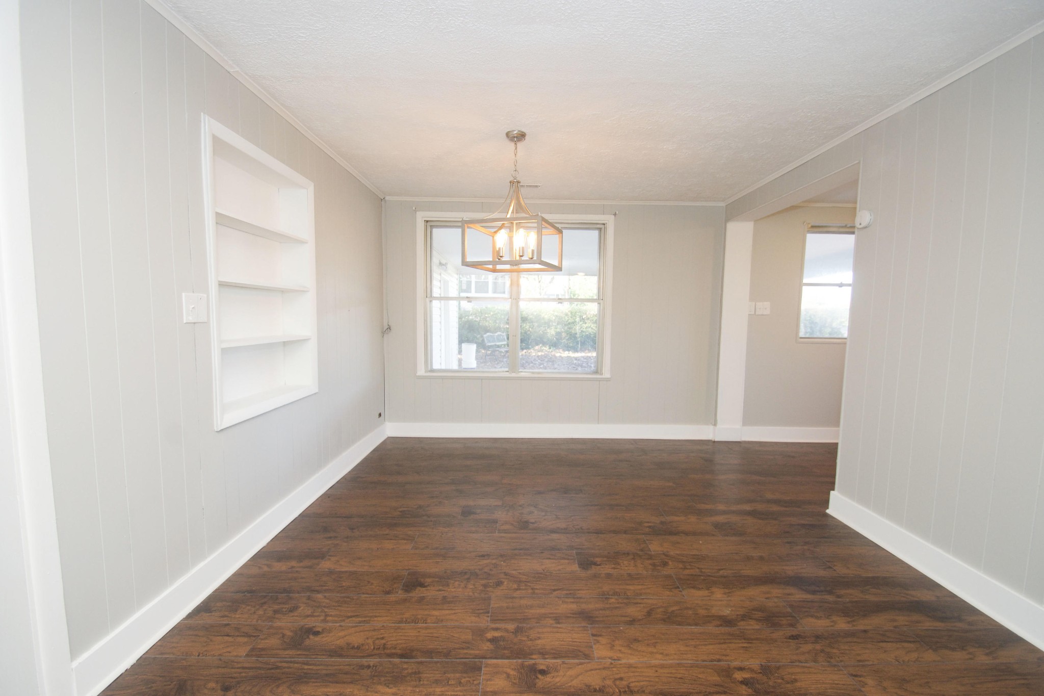 102 Goucher Circle Oak Ridge, TN 37830 - Photo 17 of 37 an empty room with wooden floor chandelier and windows