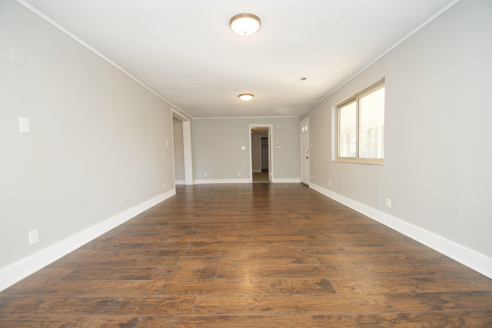 102 Goucher Circle Oak Ridge, TN 37830 - Photo 5 of 37 an empty room with wooden floor and windows