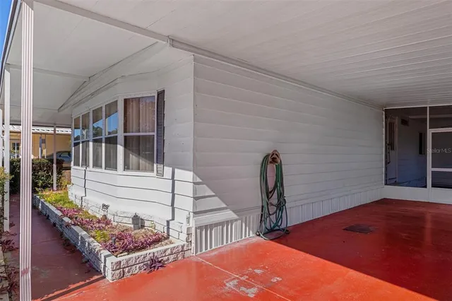 a view of a livingroom with a ceiling fan and window