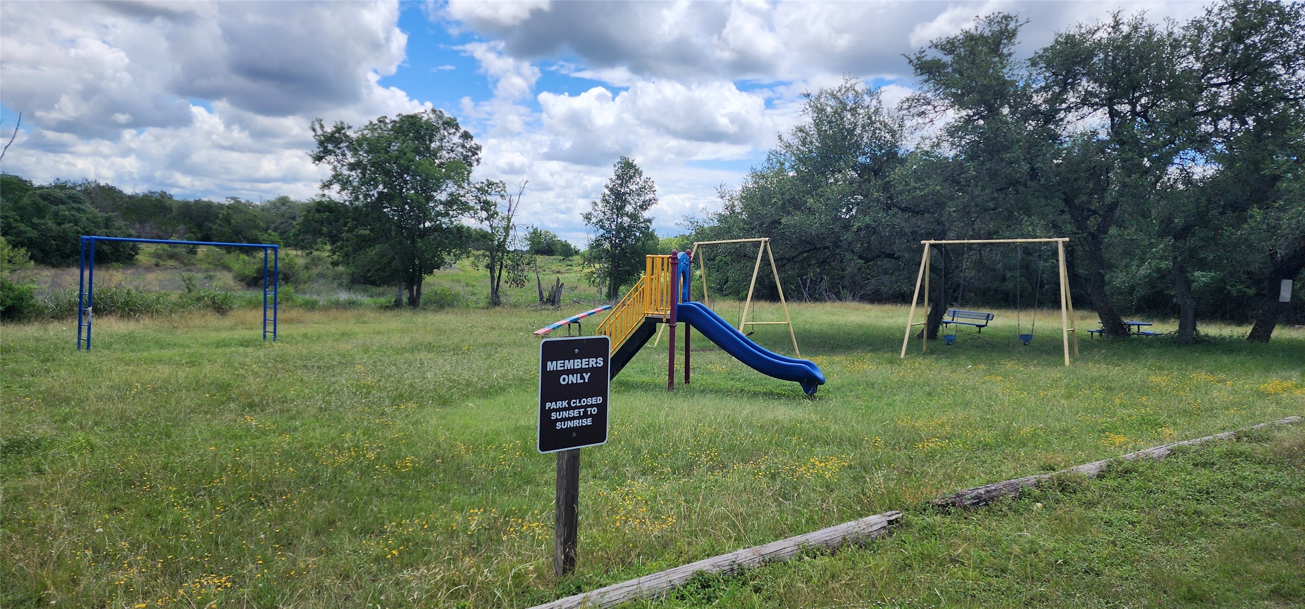 1285 Cedar Lake Spring Branch Spring Branch, TX 78070 - Photo 5 of 5 A community playground amidst natural landscaping, offering recreation with ample green space.